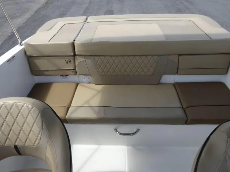 Slide: The Image of 2022 Bayliner VR4 boat interior with beige cushioned seating and diamond stitching. - 11
