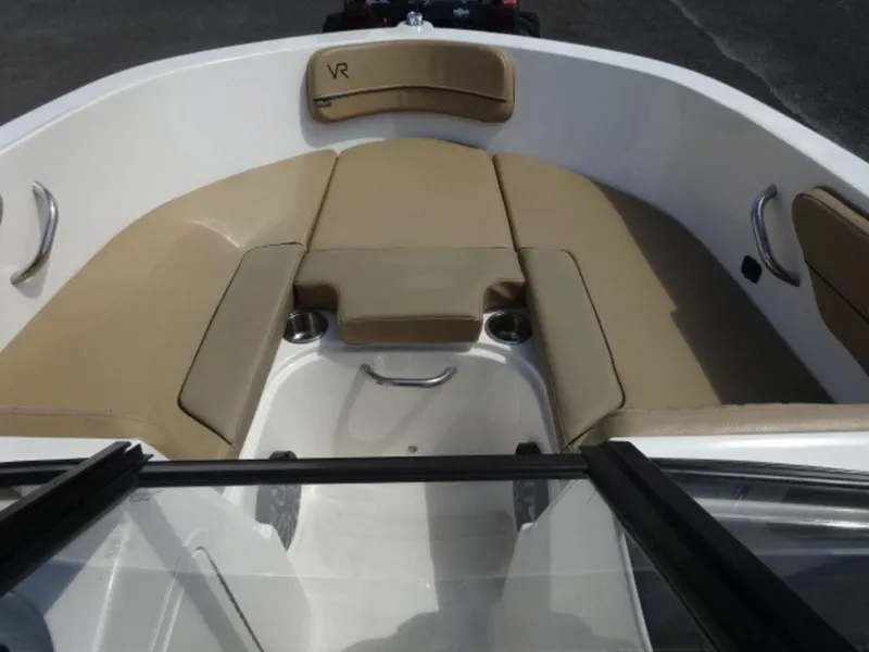 Slide: The Image of 2022 Bayliner VR4 boat interior with beige seating and stainless steel handles. - 7