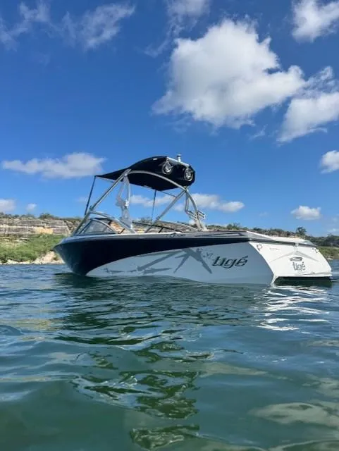 The Image of 2008 Tigé Z1 boat on water under blue sky with clouds. - 0