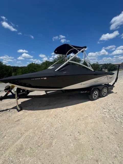 Slide: The Image of 2008 Tigé Z1 boat on trailer under clear blue sky. - 11
