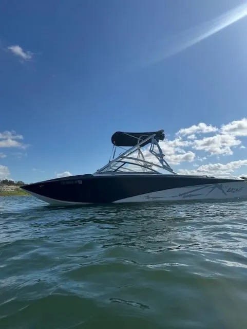 Slide: The Image of 2008 Tigé Z1 boat on water under clear blue sky. - 3