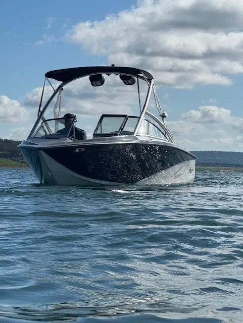 Slide: The Image of 2008 Tigé Z1 boat on water under clear sky. - 5