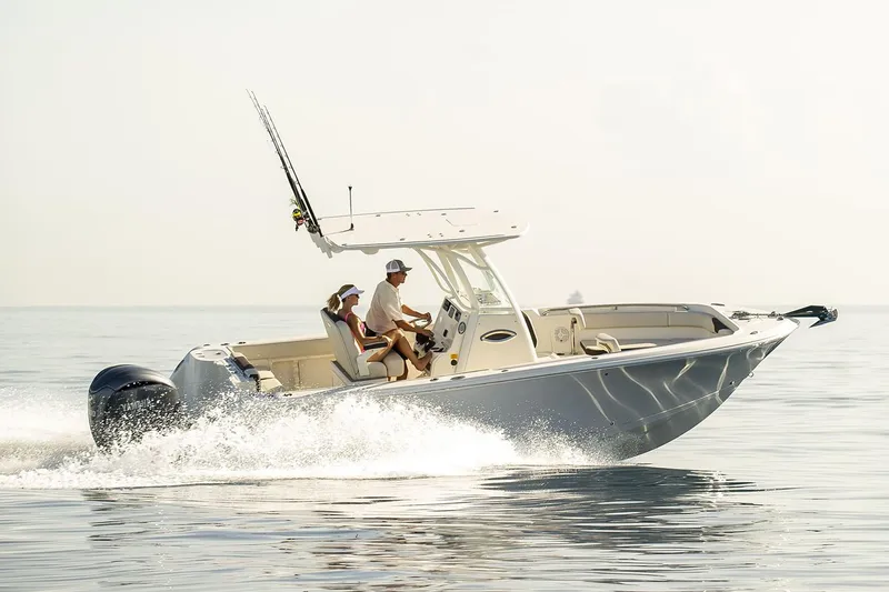 The Image of 2024 Sailfish 241 CC boat cruising on calm waters with scenic background. - 0