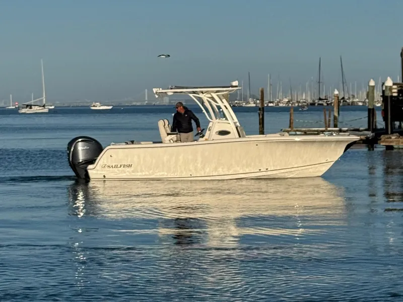 Slide: The Image of 2024 Sailfish 241 CC boat interior with storage and control panel. - 13
