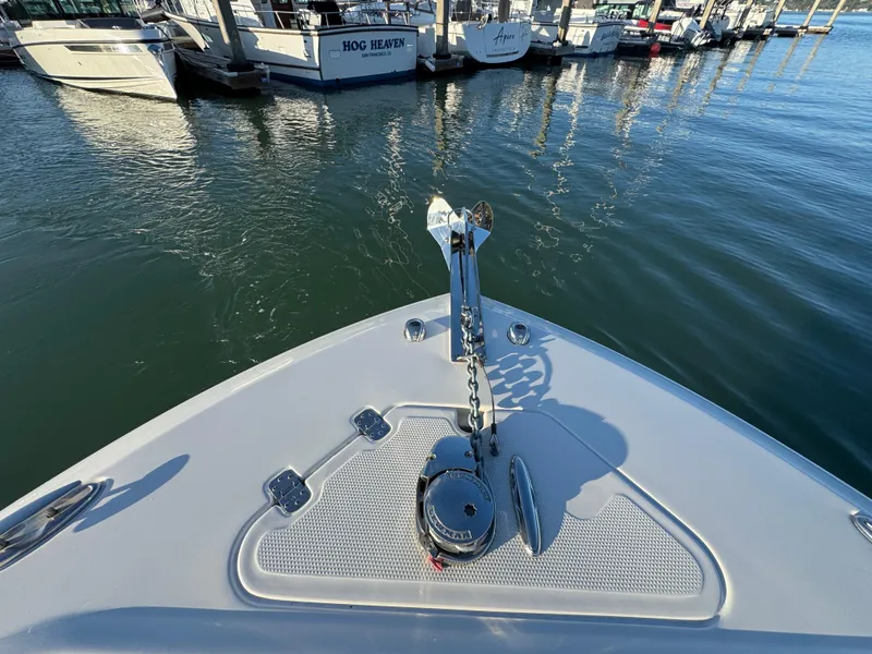 Slide: The Image of 2024 Sailfish 241 CC boat interior with modern seating and control panel at marina. - 15