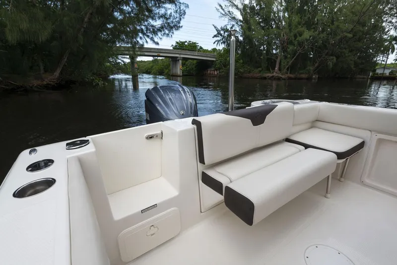 Slide: The Image of 2024 Sailfish 241 CC boat on calm water, featuring sleek design and modern controls. - 7