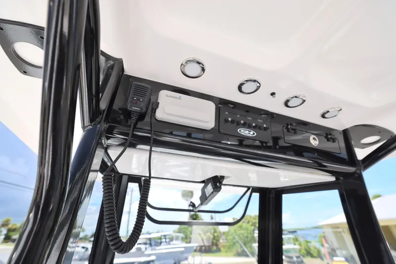 Slide: The Image of 2026 Sea Hunt Ultra 265 SE boat interior with plush seating and dual outboard motors. - 10