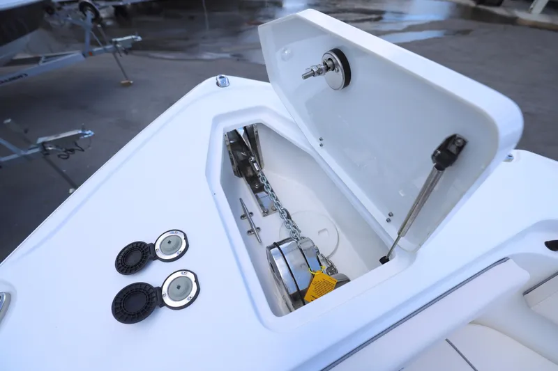 Slide: The Image of Interior of 2026 Sea Hunt Ultra 265 SE boat, featuring a compact marine toilet. - 11