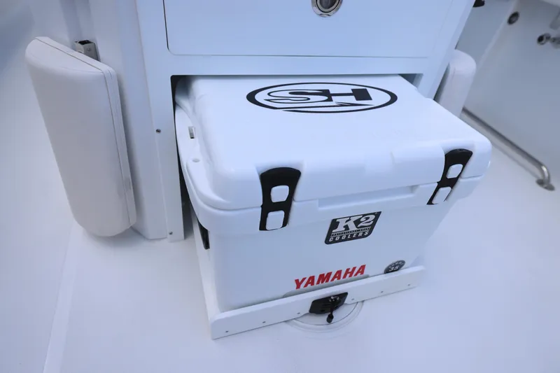 Slide: The Image of 2026 Sea Hunt Ultra 265 SE with dual Yamaha 150 outboard engines, parked on grass. - 12