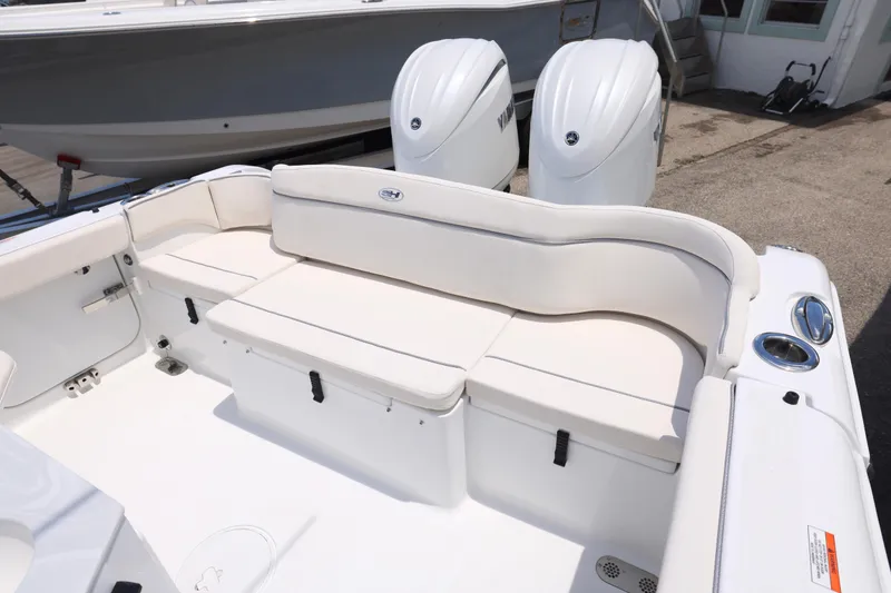 Slide: The Image of 2026 Sea Hunt Ultra 265 SE boat interior with white seating and storage compartments. - 13