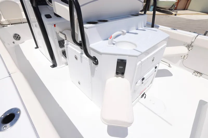 Slide: The Image of 2026 Sea Hunt Ultra 265 SE boat interior with cup holders and seating. - 15