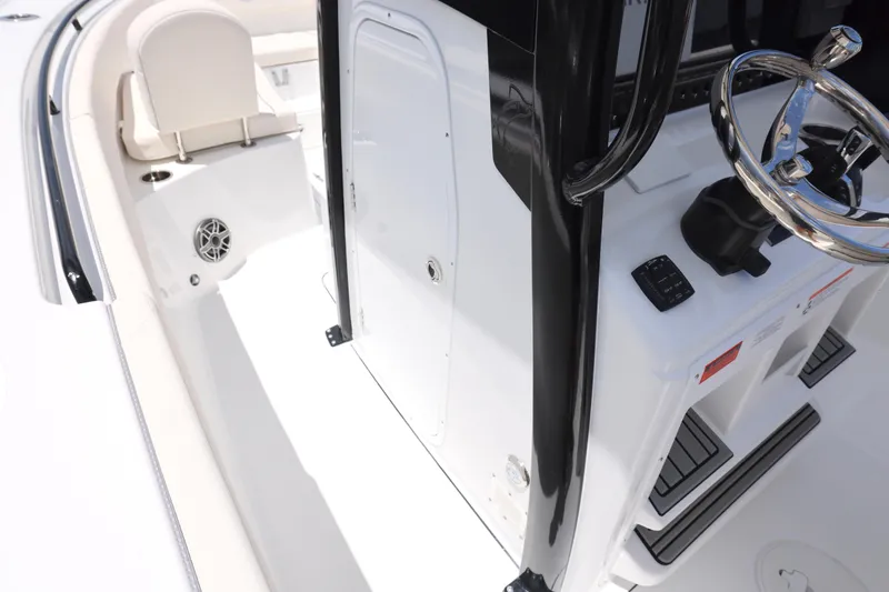 Slide: The Image of 2026 Sea Hunt Ultra 265 SE boat interior with cushioned seating and storage compartments. - 18