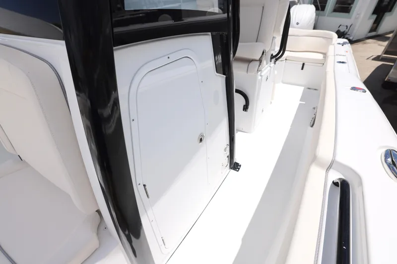 Slide: The Image of 2026 Sea Hunt Ultra 265 SE boat with sleek T-top design against blue sky. - 19