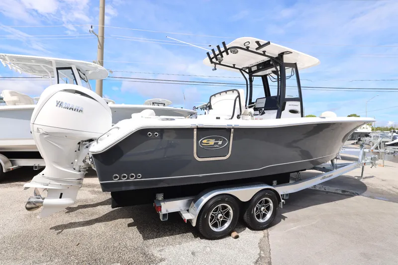 Slide: The Image of Family enjoying a day on a 2025 Sea Hunt Ultra 265 SE boat. - 25
