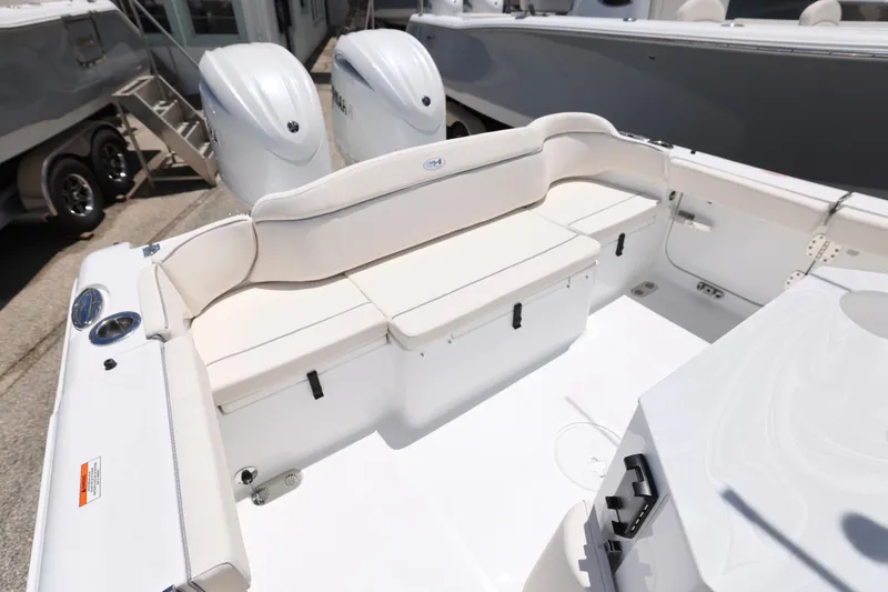 Slide: The Image of 2026 Sea Hunt Ultra 265 SE boat interior with white seating and speakers. - 3