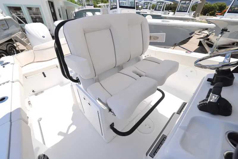 Slide: The Image of 2026 Sea Hunt Ultra 265 SE boat with T-top and seating, under clear blue sky. - 7