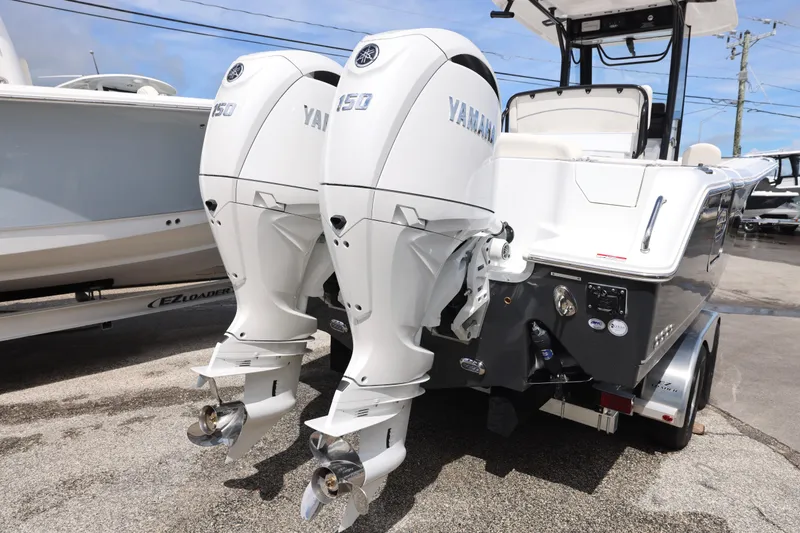 Slide: The Image of 2026 Sea Hunt Ultra 265 SE boat top with rod holders and speakers against blue sky. - 8