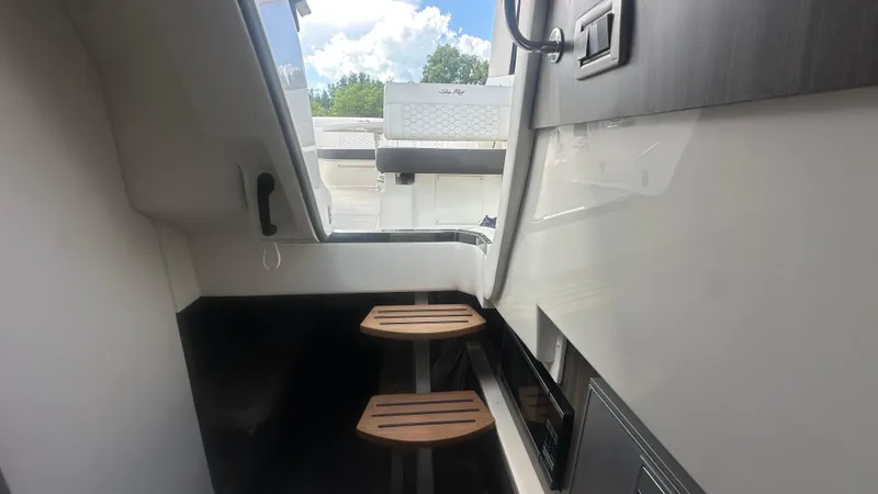 Slide: The Image of 2023 Sea Ray Sundancer 320 Outboard interior with wooden steps and sleek design. - 10