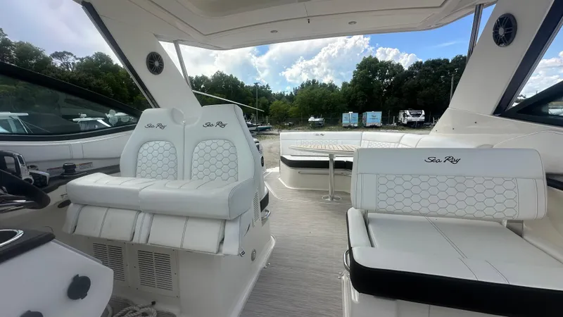 Slide: The Image of 2023 Sea Ray Sundancer 320 Outboard interior with luxurious white seating and modern design. - 11