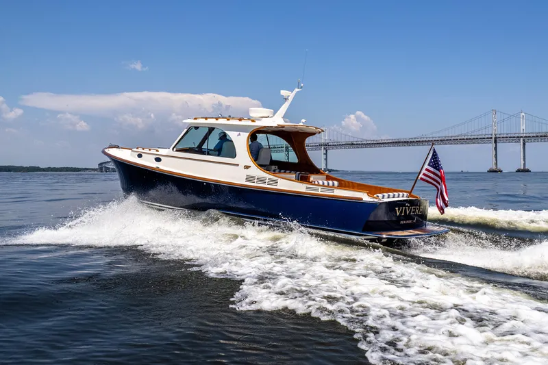 Slide: The Image of 2015 Hinckley Picnic Boat 37 MKIII cruising near a bridge on a sunny day. - 11