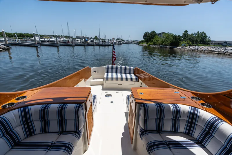 Slide: The Image of Hinckley Picnic Boat 37 MKIII, 2015, with striped seating, docked in a serene marina. - 17