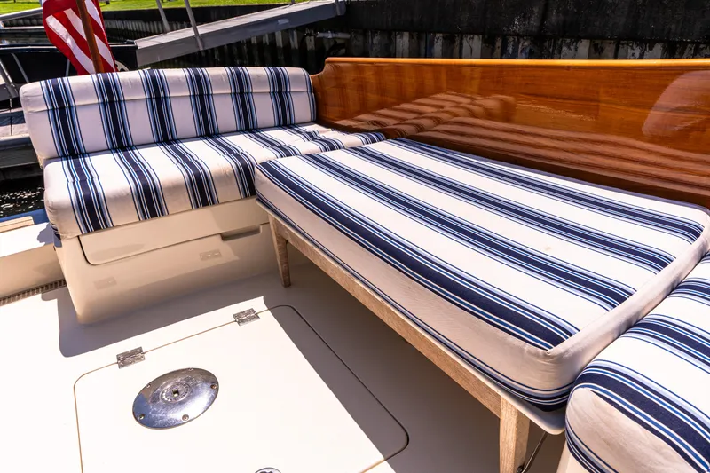 Slide: The Image of Striped seating on 2015 Hinckley Picnic Boat 37 MKIII deck, featuring elegant wood finish. - 19