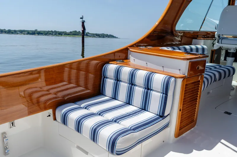 Slide: The Image of 2015 Hinckley Picnic Boat 37 MKIII with striped seating and polished wood interior. - 20
