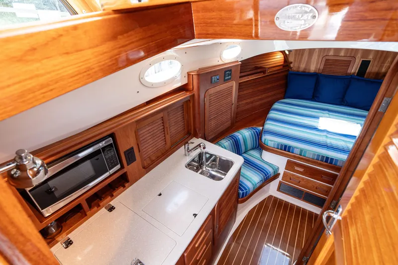 Slide: The Image of Luxurious interior of 2015 Hinckley Picnic Boat 37 MKIII with wood finish and cozy seating. - 30