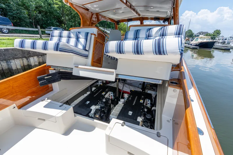 Slide: The Image of 2015 Hinckley Picnic Boat 37 MKIII with open engine compartment and striped seating. - 37