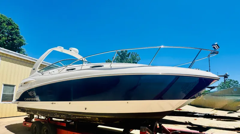 The Image of 2005 Chaparral Signature 270 boat on trailer, blue sky. - 0