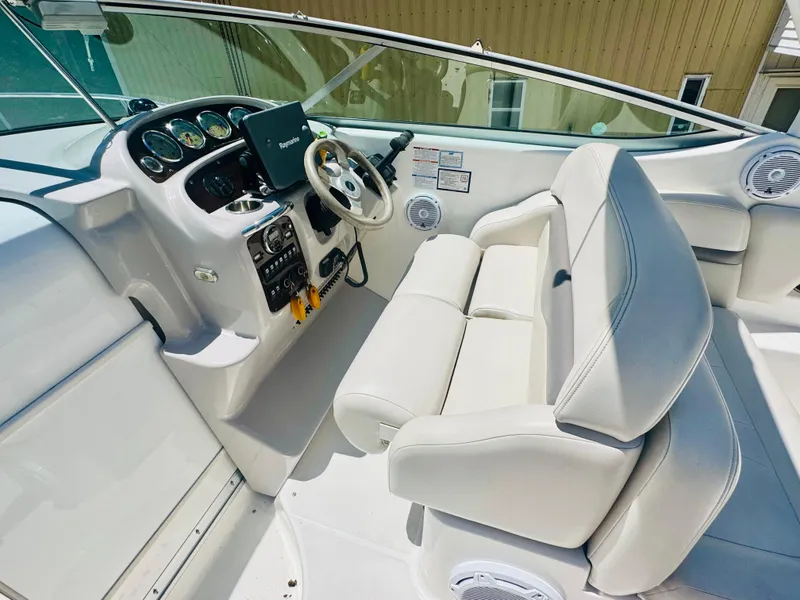 Slide: The Image of Interior of a 2005 Chaparral Signature 270 boat with helm console. - 15