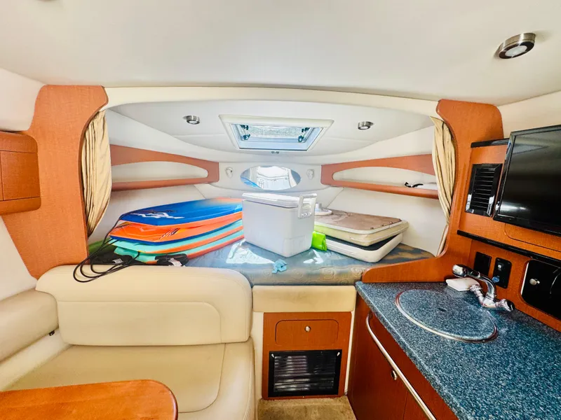 Slide: The Image of Interior of 2005 Chaparral Signature 270 with surfboards and cooler. - 22