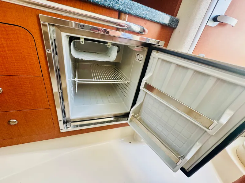 Slide: The Image of Open fridge in a 2005 Chaparral Signature 270 yacht. - 23