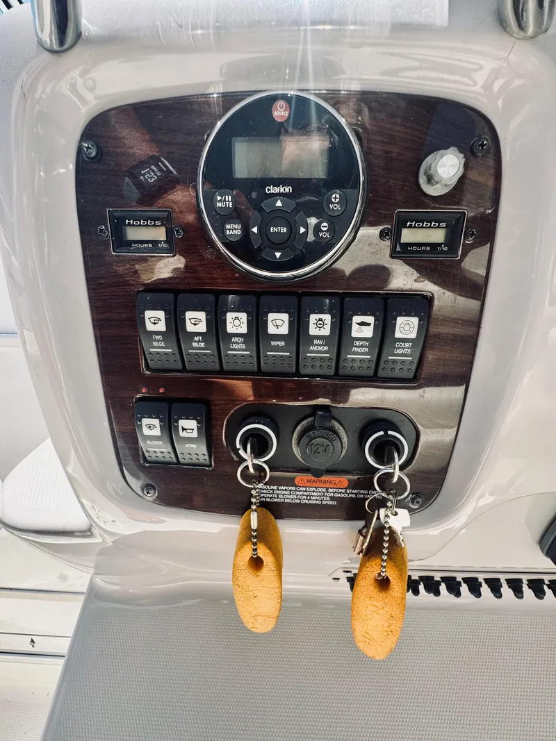 Slide: The Image of Dashboard of a 2005 Chaparral Signature 270 boat with switches and keys. - 29