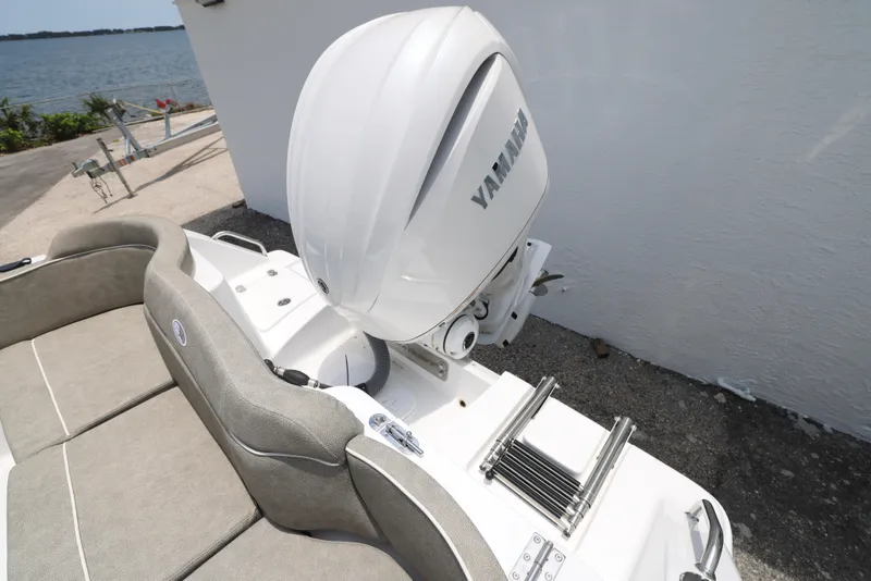 Slide: The Image of 2026 Sea Hunt Ultra 245 SE boat interior with cushioned seating and storage compartment. - 12