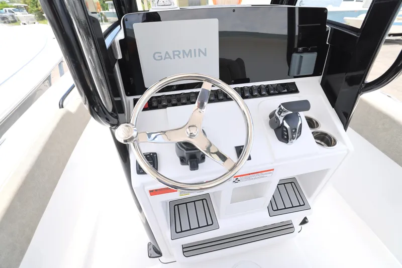 Slide: The Image of 2026 Sea Hunt Ultra 245 SE boat console with Garmin electronics and controls. - 17
