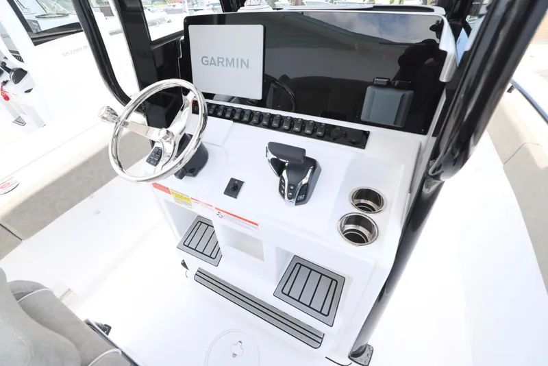 Slide: The Image of 2026 Sea Hunt Ultra 245 SE boat interior with cushioned seating and modern design. - 22