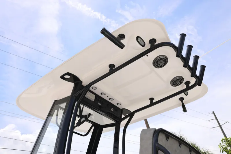 Slide: The Image of 2026 Sea Hunt Ultra 245 SE boat on trailer, parked outdoors, surrounded by greenery. - 27