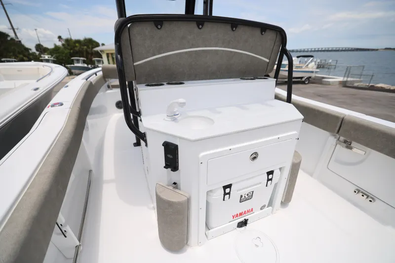 Slide: The Image of 2026 Sea Hunt Ultra 245 SE boat with powerful outboard motor, parked outdoors. - 3