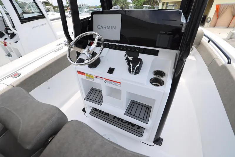 Slide: The Image of 2026 Sea Hunt Ultra 245 SE boat interior with cushioned seating and cup holders. - 7
