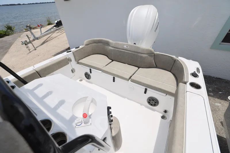 Slide: The Image of 2026 Sea Hunt Ultra 245 SE boat with Yamaha outboard motor, docked near water. - 9
