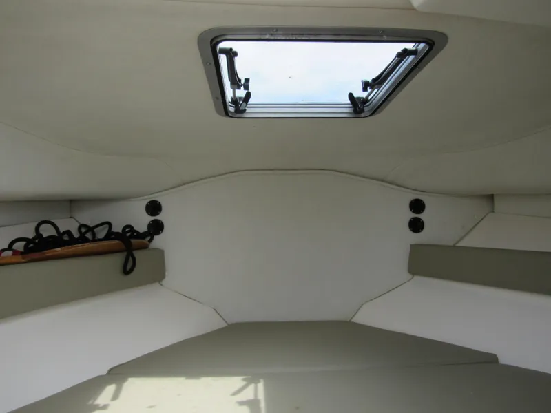 Slide: The Image of Interior cabin of a 1997 Boston Whaler 23 Conquest boat with a ceiling hatch. - 11