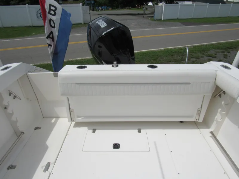 Slide: The Image of 1997 Boston Whaler 23 Conquest boat interior with seating and outboard motor. - 16