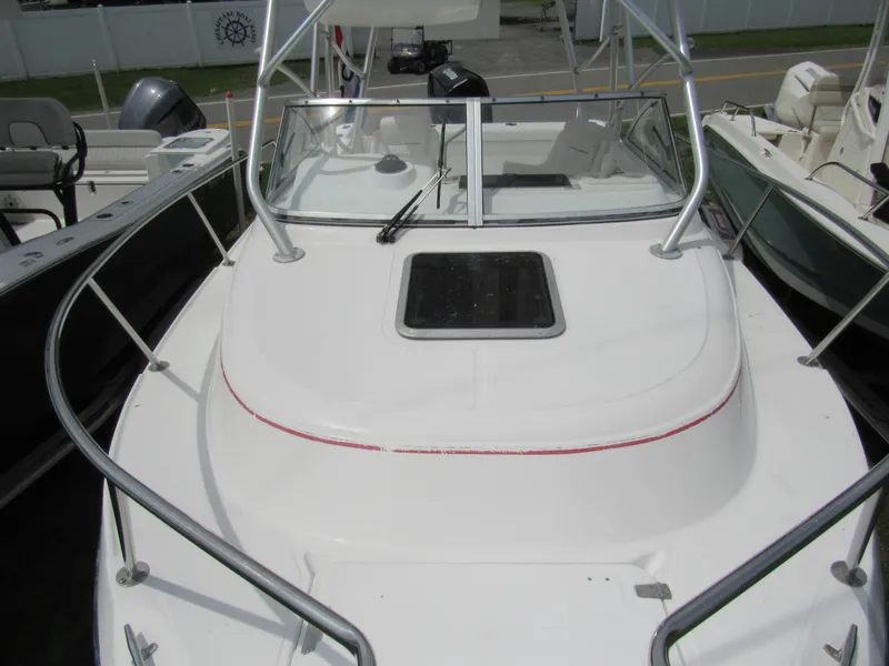 Slide: The Image of 1997 Boston Whaler 23 Conquest boat deck with windshield and railing. - 20