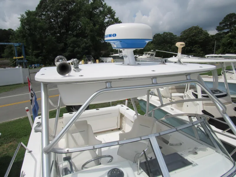 Slide: The Image of 1997 Boston Whaler 23 Conquest boat with radar, docked outdoors. - 21