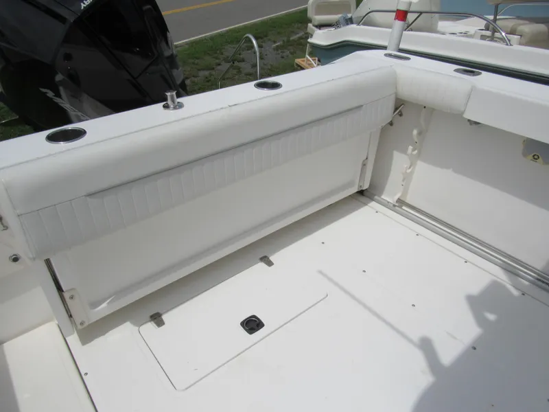 Slide: The Image of 1997 Boston Whaler 23 Conquest boat interior with seating and storage compartments. - 22