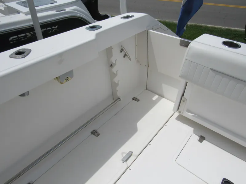 Slide: The Image of 1997 Boston Whaler 23 Conquest boat interior with rod holders and seating. - 23