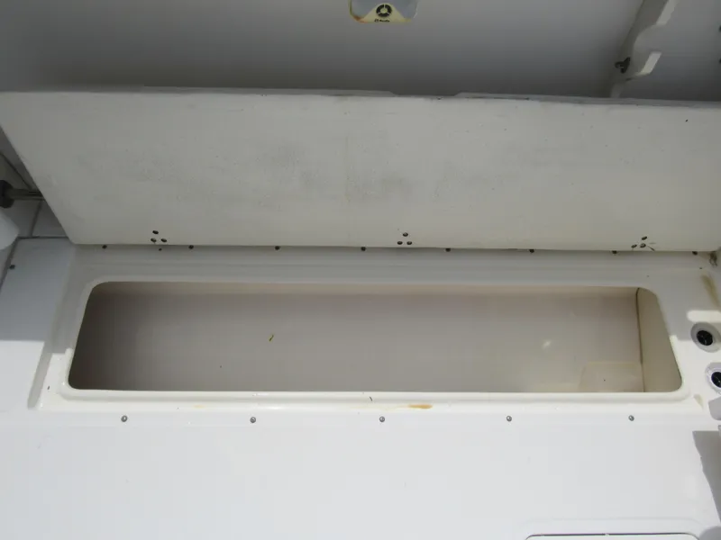 Slide: The Image of 1997 Boston Whaler 23 Conquest storage compartment, open and empty. - 24