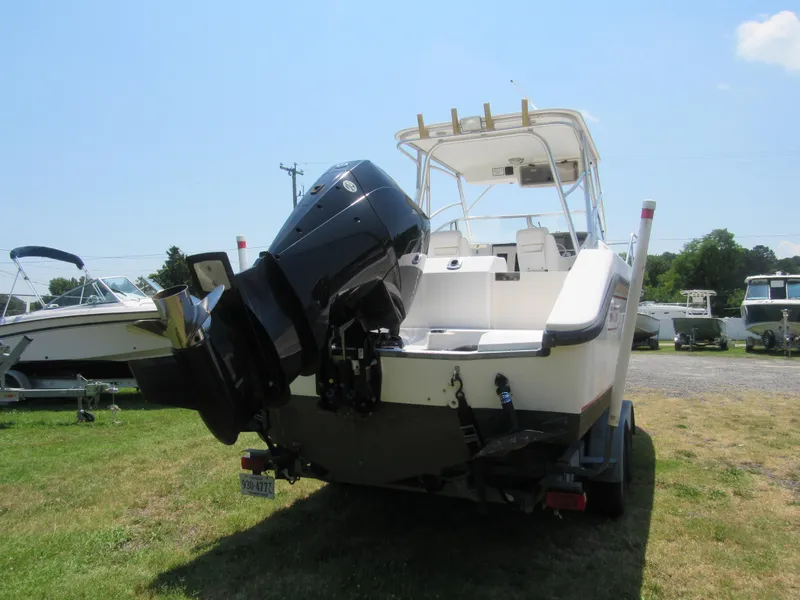 Slide: The Image of 1997 Boston Whaler 23 Conquest boat with powerful outboard motor on trailer. - 3