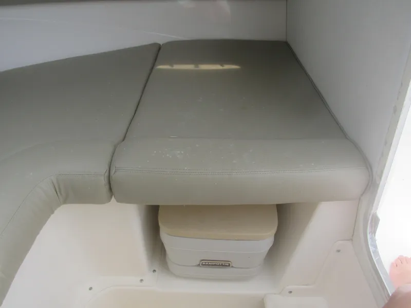 Slide: The Image of Interior cabin of 1997 Boston Whaler 23 Conquest with cushioned seating and portable toilet. - 6